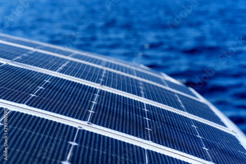 Tableau sur toile Close up view part of solar panel on dock of sailboat and blue sea waters during