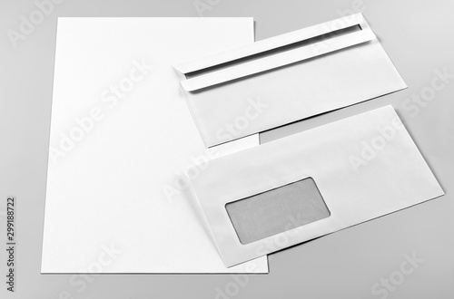 Blank Letterhead and Two Envelopes over Grey Background