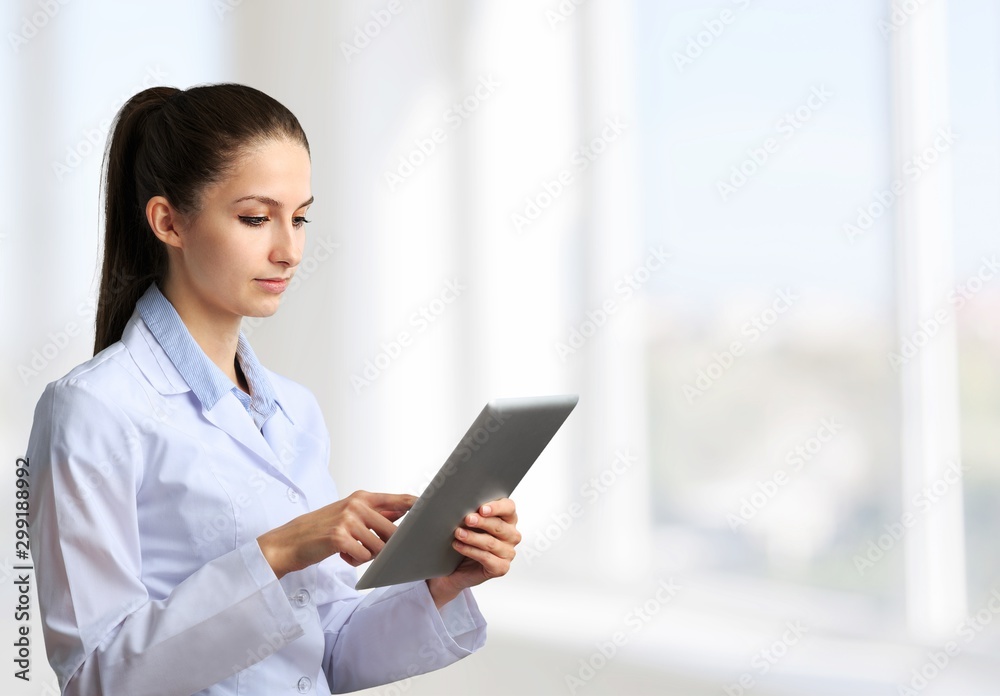 Male doctor with stethoscope on blurred hospital background Male doctor with stethoscope on blurred hospital background