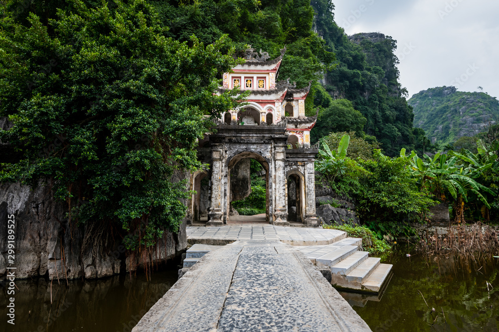 Fototapeta premium Beautiful Bich Dong Pagoda entrance in Tam Coc, Ninh Binh, Northern Vietnam shot in October 2019 on a bright day