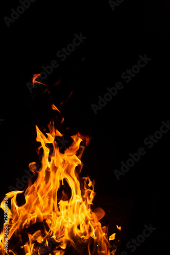hot orange fire on black background © Sandu