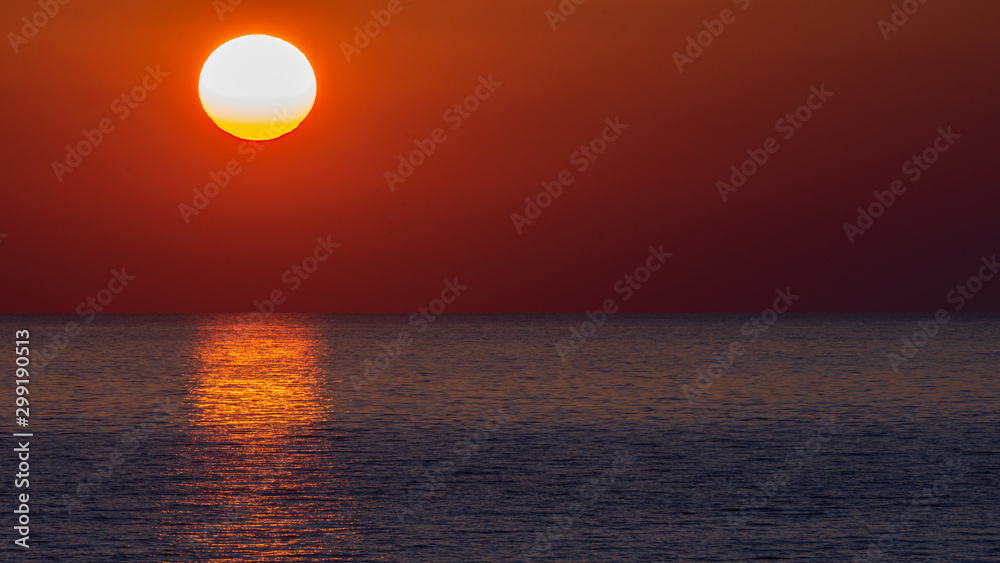A beautiful Croatian coastal sunset overlooking the Adriatic Sea. Sunset horizon sea water landscape. Sunset sea horizon panorama.