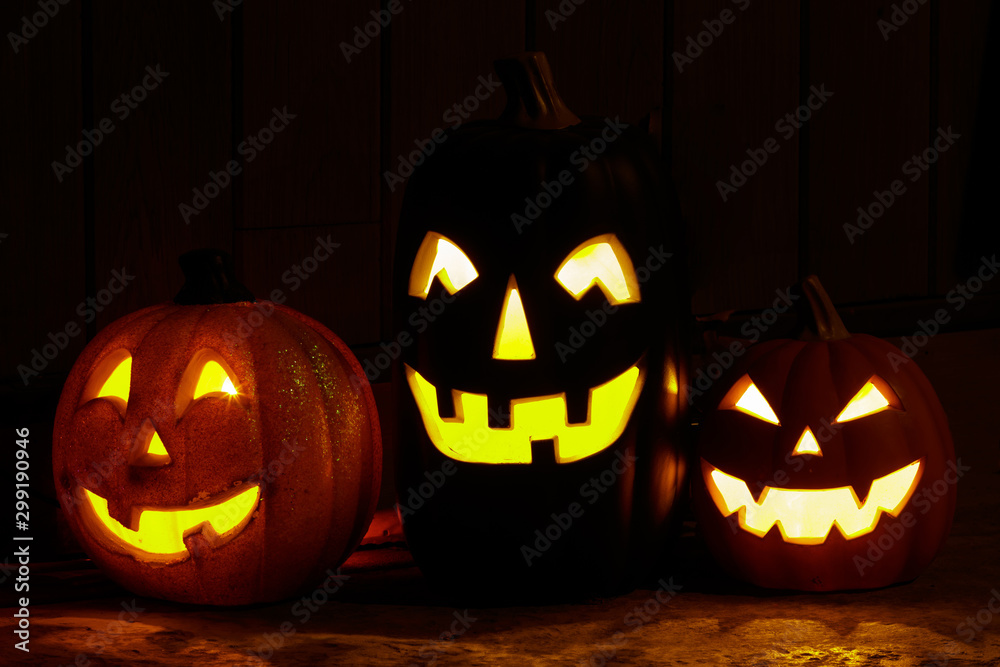 Three Jack O Lantern Pumpkin Lanterns Glowing in the Dark. Three Jack O Lantern Pumpkin Lanterns Glowing in the Dark.