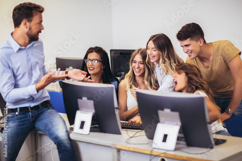 College students sitting in a classroom, using computers during class.