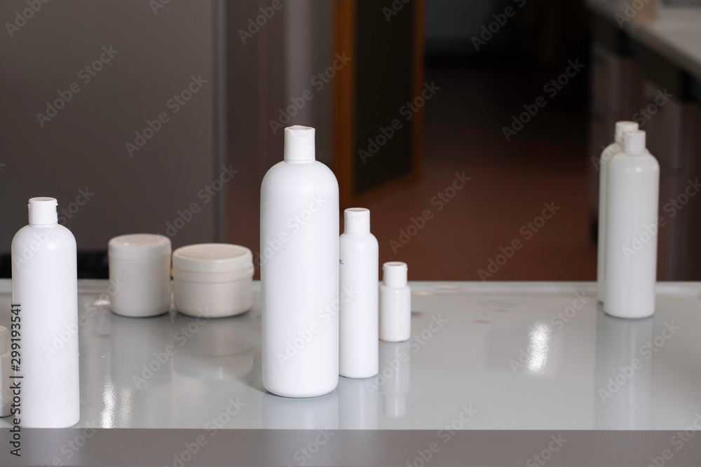 Different cosmetic products on white table Different cosmetic products on white table