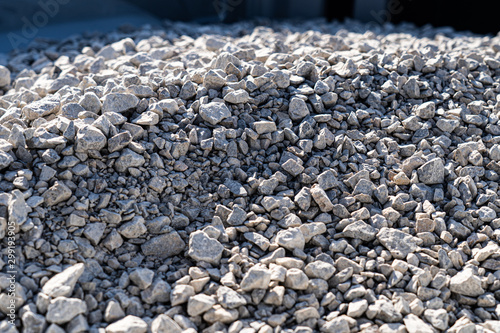A large pile of bulk 57 gravel sits ready to be used on a job site for a DIY home improvement project