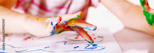 Close up young girl painting with colorful hands. Art,  creativity and painti...