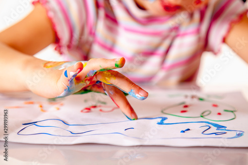 Fototapeta Naklejka Na Ścianę i Meble -  Young girl painting with colorful hands. Art,  creativity and painting concept.