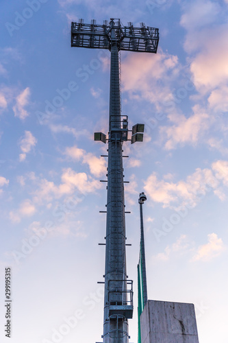 Stadium lights tower with clouds in the background