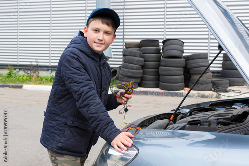 Child mechanic working in the garage. Repair service. photo