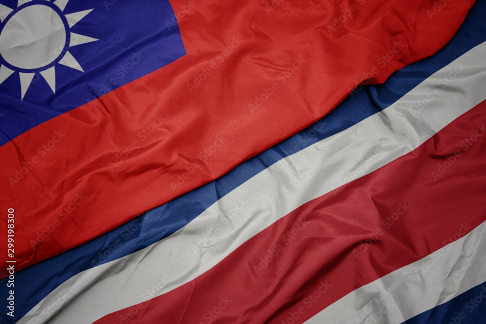 waving colorful flag of costa rica and national flag of taiwan.