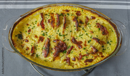 Roasted chicken breast and bacon with cream sauce and parsley