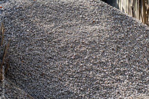 A large pile of bulk 57 gravel sits ready to be used on a job site for a DIY home improvement project