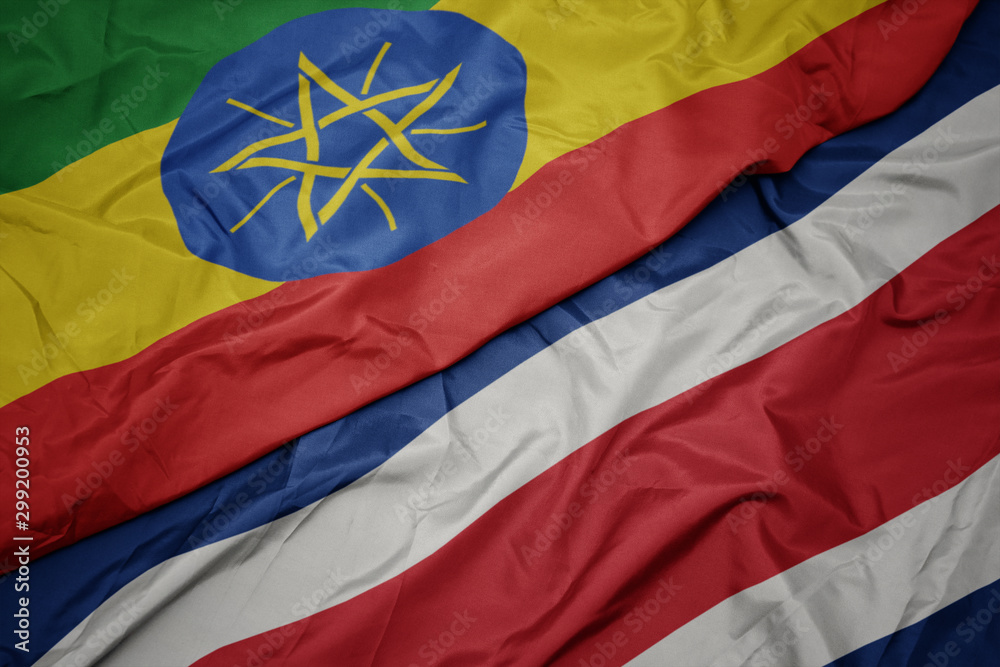 waving colorful flag of costa rica and national flag of ethiopia .