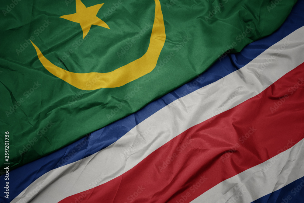 waving colorful flag of costa rica and national flag of mauritania. waving colorful flag of costa rica and national flag of mauritania.