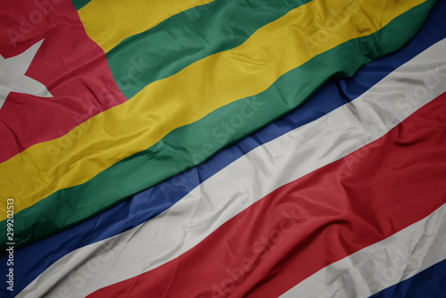 waving colorful flag of costa rica and national flag of togo.