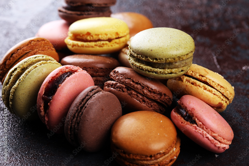 Sweet and colourful french macaroons or macaron on dark black background, Dessert. Sweet and colourful french macaroons or macaron on dark black background, Dessert.