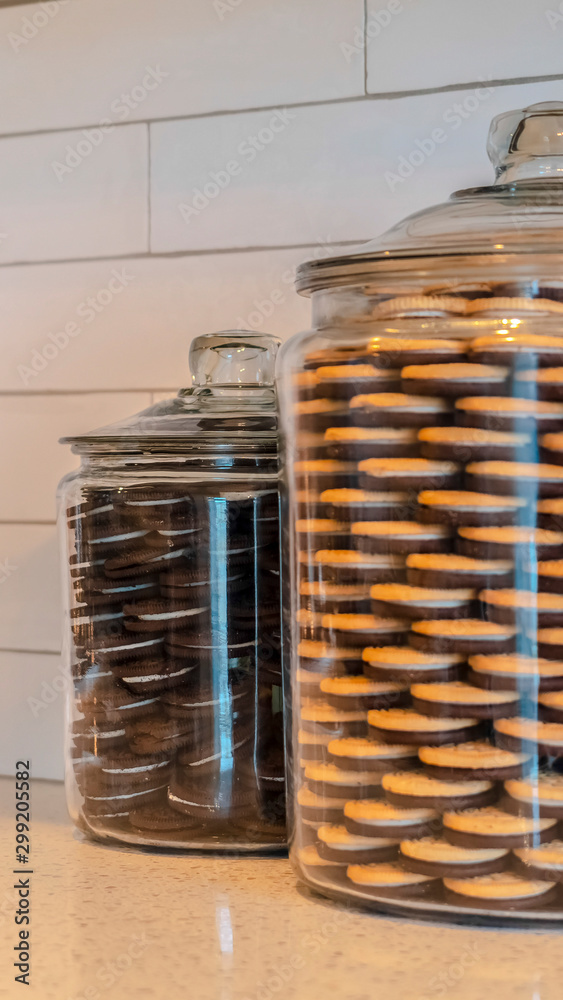 Vertical Large glass jars filled with cookies in kitchen Stock Photo |  Adobe Stock