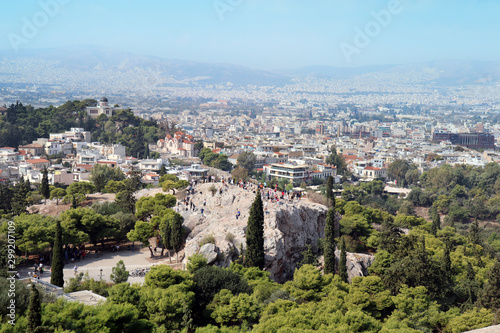 View from Acropolis. St. Marei church to the left. Tourists taking photos of the Acropolis from a distance. View of the capital in the background.