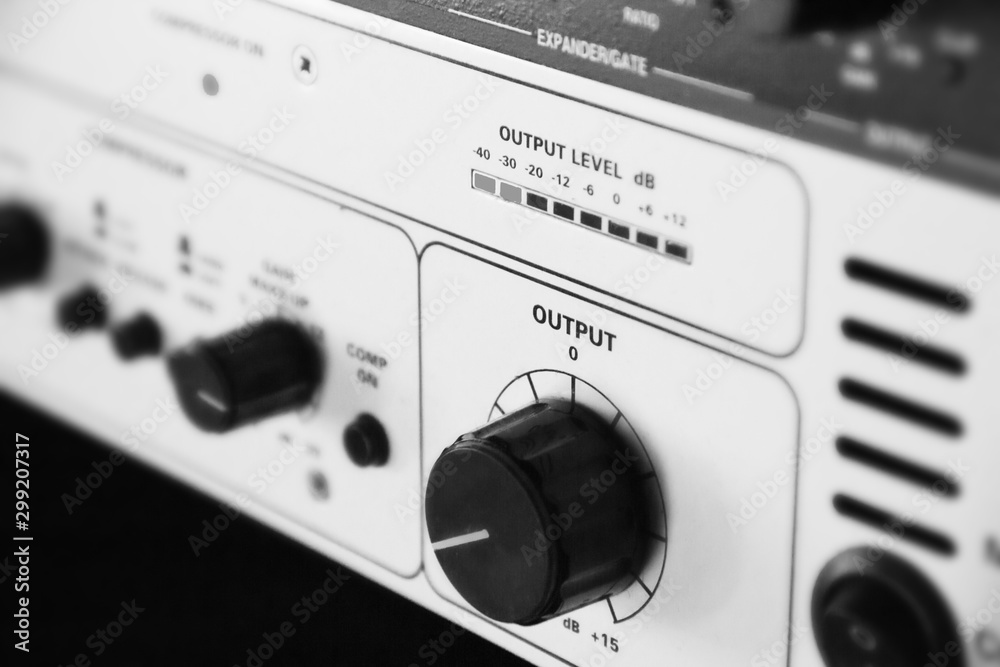 A rack of audio compressors in a recording studio. A rack of audio compressors in a recording studio.