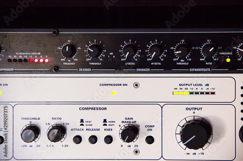 A rack of audio compressors in a recording studio. © GMars