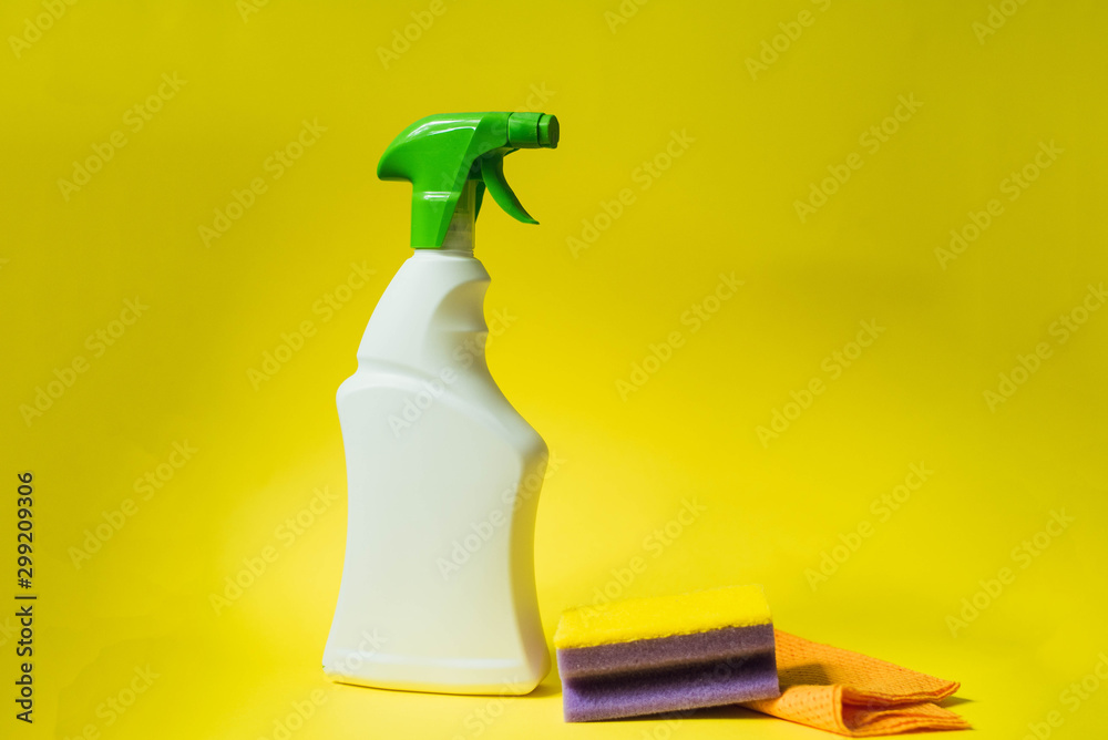 Detergent, sponge and gloves for cleaning the house on a yellow bright background. The concept of cleaning, cleansing and bleaching Detergent, sponge and gloves for cleaning the house on a yellow bright background. The concept of cleaning, cleansing and bleaching