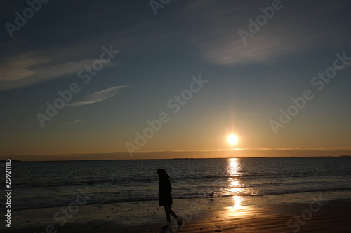Silhouette of Man Walking on the Beach Sunrise