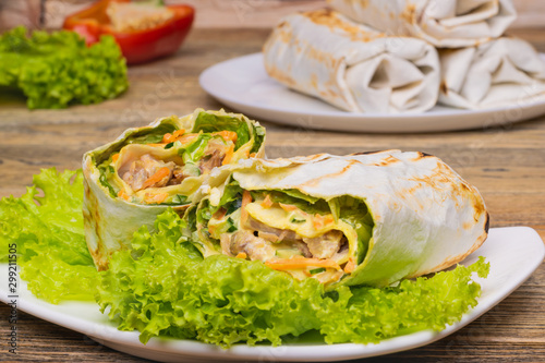 Thin pita bread filling with pork and vegetables. Lavash roll