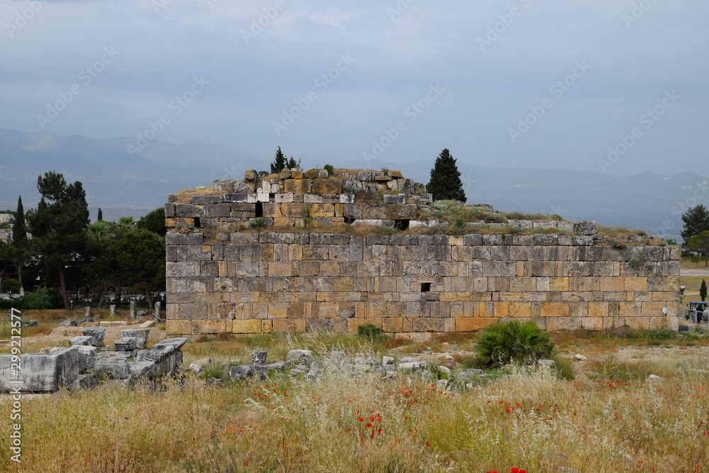 remains of the ancient antique buildings of Hierapolis from limestone blocks, dilapidated walls.