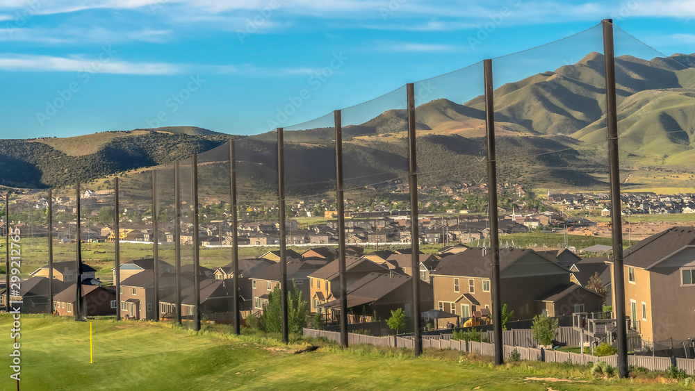 Panorama Residential houses and mountain on the other side of the golf course fence Panorama Residential houses and mountain on the other side of the golf course fence
