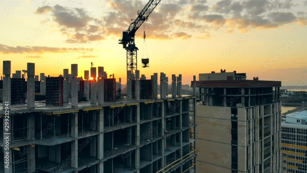 Modern crane works with building on a site.