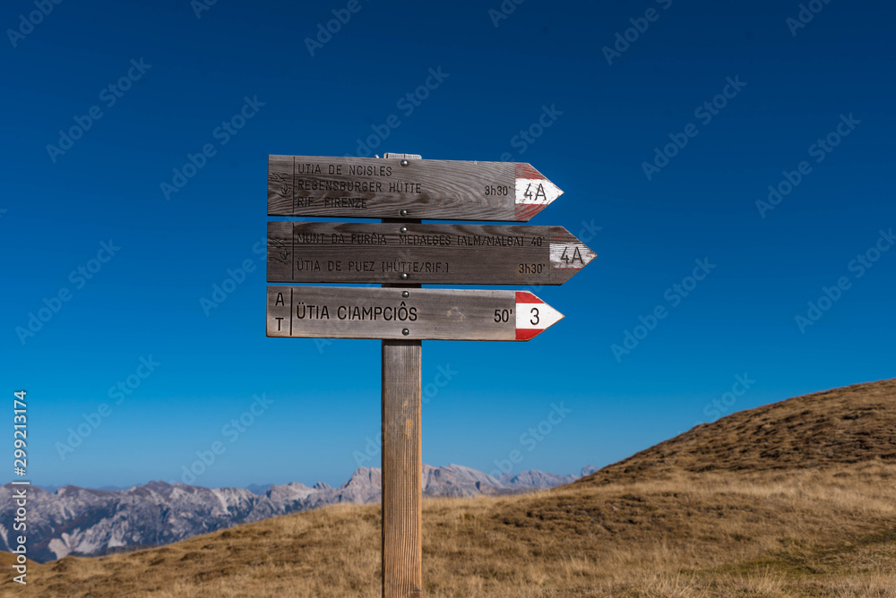 wooden sign in the mountains, dolomite alps, south tyrol