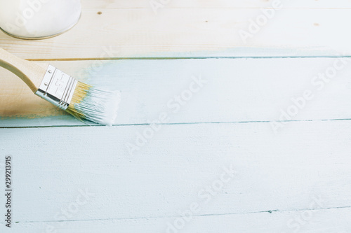 Paint brush with light blue paint on white background. Color of the Year 2020 - Bleached Coral. Renovation concept. Copy Space. Selective focus