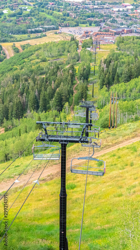 Vertical frame Chairlifts with amazing view of ski resort blanketed in greenery at off season
