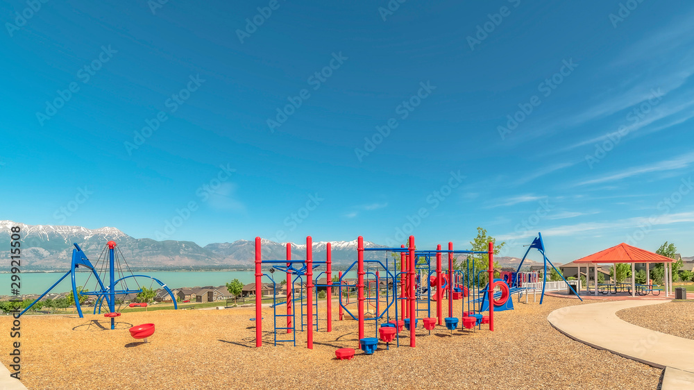 Panorama Playground and pavilion at a park with lake and snow capped mountain bakcground Panorama Playground and pavilion at a park with lake and snow capped mountain bakcground