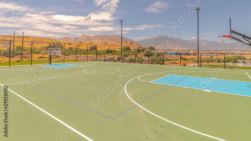 Panorama frame Outdoor turf basketball court on sunny, clear day © Jason