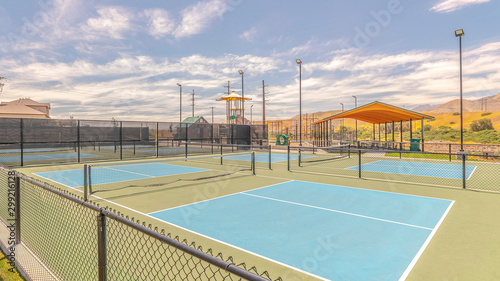 Panorama frame Outdoor tennis courts and sunny recreational park © Jason