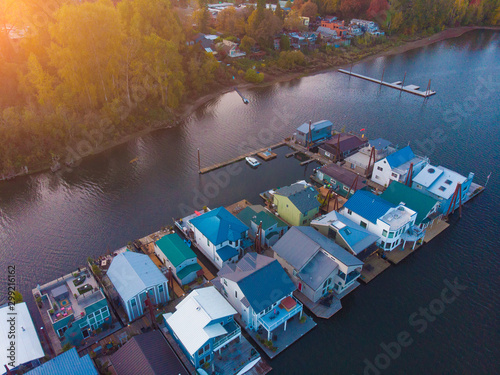 A pier with houses on the water in the USA at sunset in autumn, shot from above using a drone