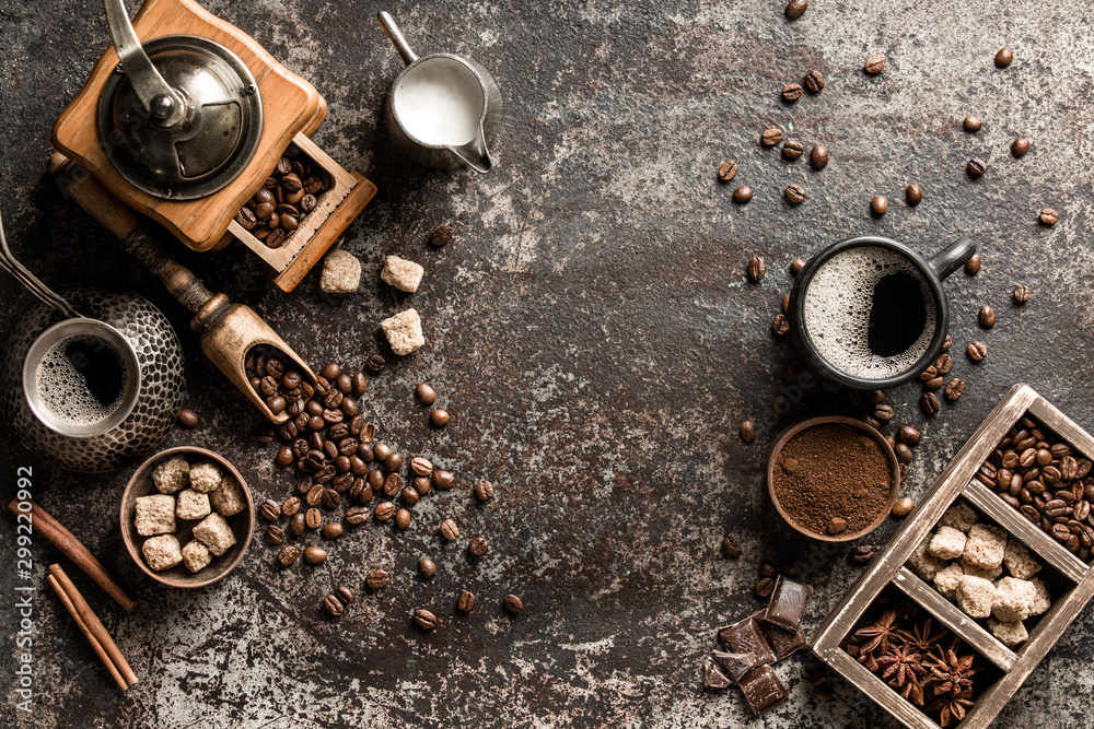 Coffee cup with coffee grinder and coffee beans on dark textured background. Coffee cup with coffee grinder and coffee beans on dark textured background.