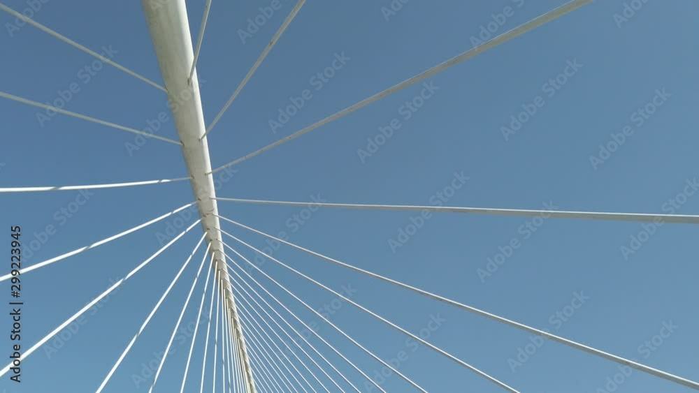stabilized shot with movement of cables from a bridge and blue sky in the background stabilized shot with movement of cables from a bridge and blue sky in the background