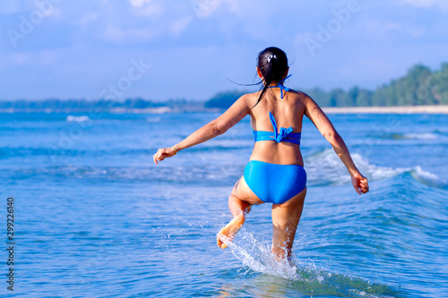 Woman and bikini blue beautiful jump on wave at beach