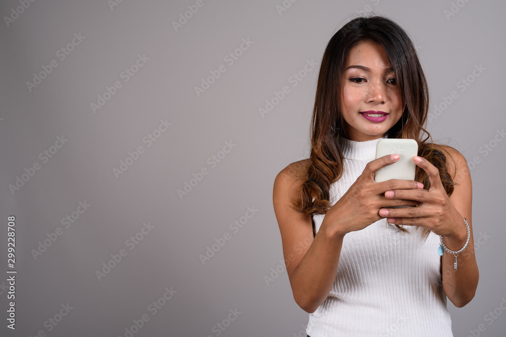 Portrait of Asian woman with wavy hair using phone Portrait of Asian woman with wavy hair using phone