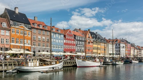 Colorful houses facades and sailing boats at Nyhavn canal, one of the most vibrant places in Copenhagen, Denmark photo