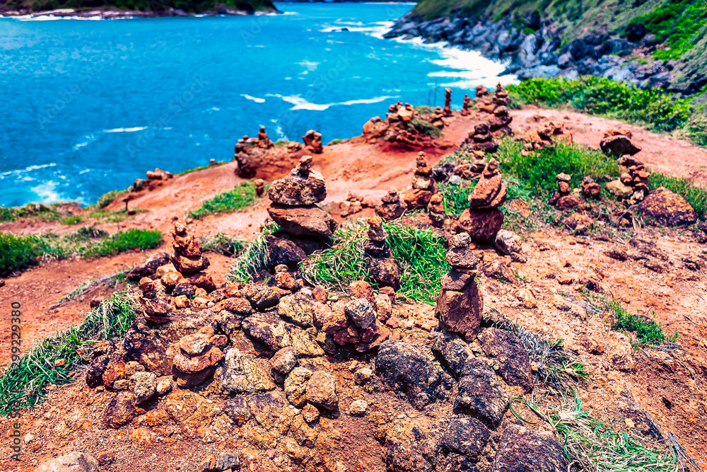 Rock statues made by tourists and locals for luck on sandy shores.