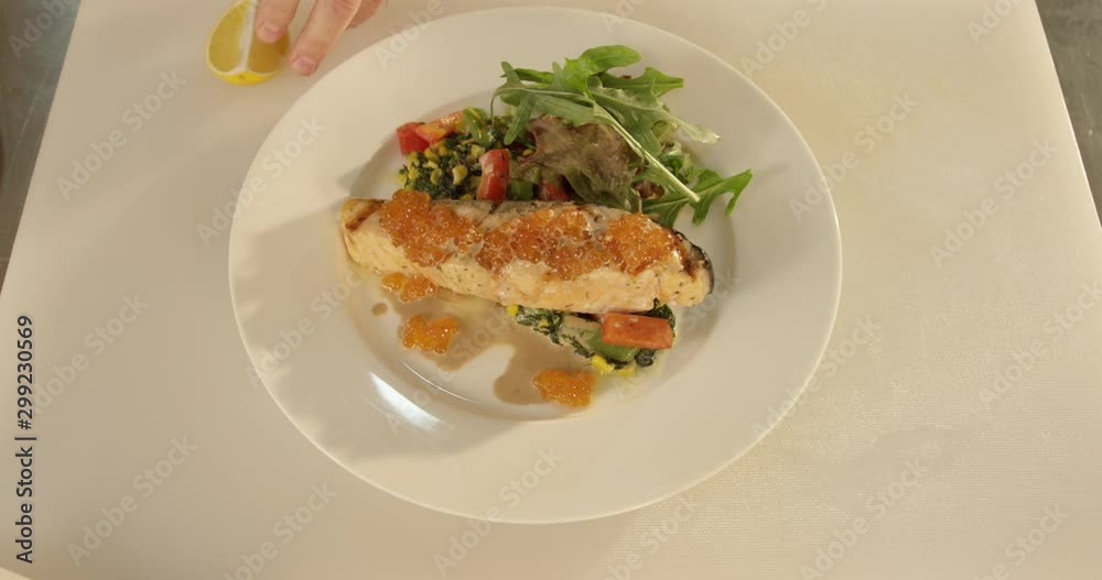 Cooking: serving of fish stake with veggies and caviar close up Cooking: serving of fish stake with veggies and caviar close up