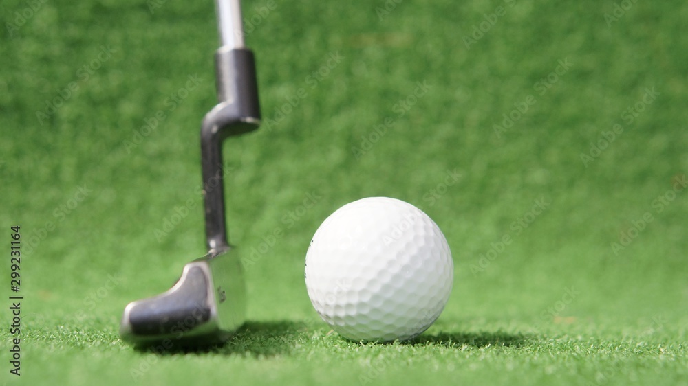 Obraz premium Golf putter and golf ball on green grass