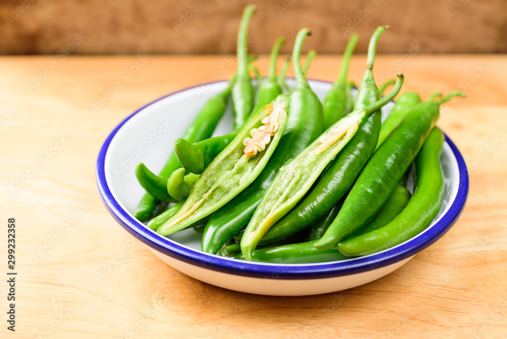 Green peppers for cooking on wooden background Green peppers for cooking on wooden background