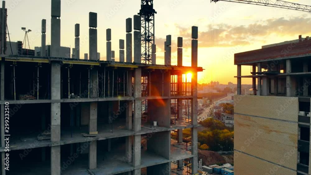 High building and crane on construction site.