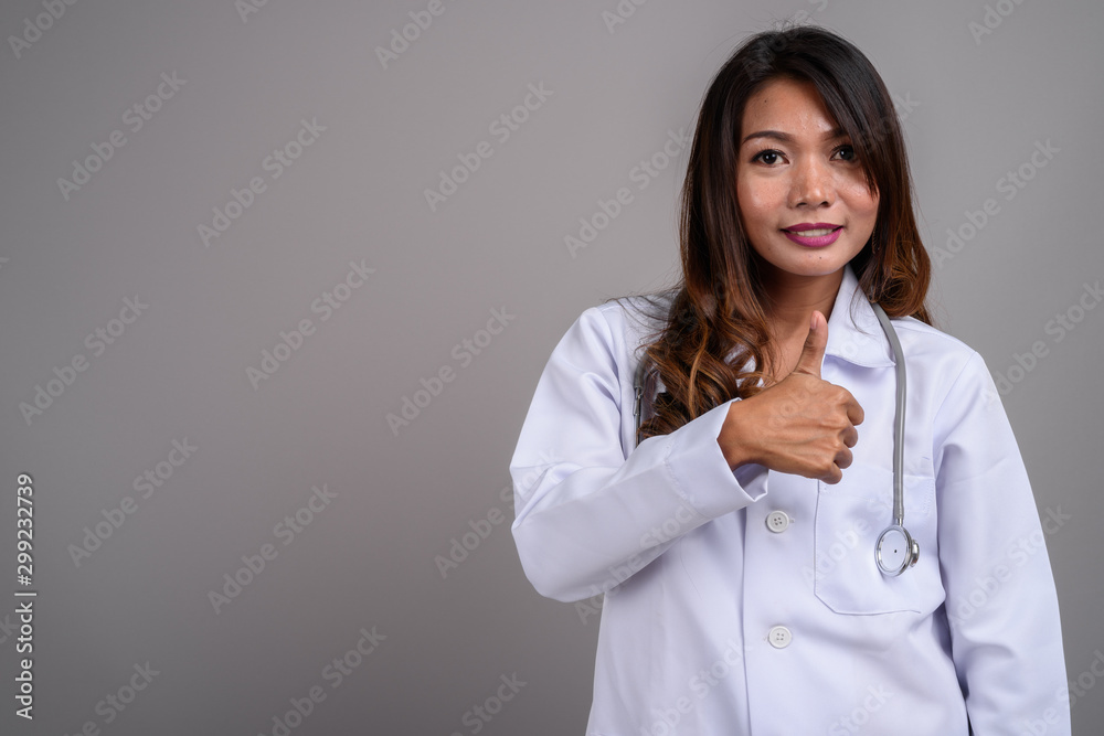 Portrait of Asian woman doctor giving thumbs up Portrait of Asian woman doctor giving thumbs up