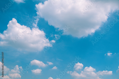 Deep blue sky and white cloud background.
